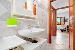 a bathroom with a sink and a mirror at Villa Bianca in San Teodoro +16 photos