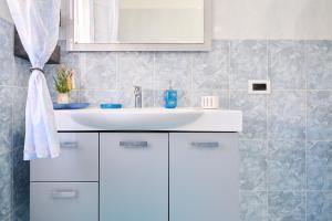 a bathroom with a white sink and a mirror at Casa laureta in Piombino
