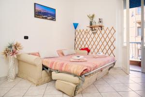 a bedroom with a bed and a couch in it at Casa laureta in Piombino