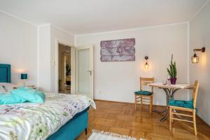a bedroom with a bed and a table and chairs at Mein lieber Schwan in Lindau