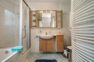 a bathroom with a sink and a mirror at Mein lieber Schwan in Lindau +18 photos