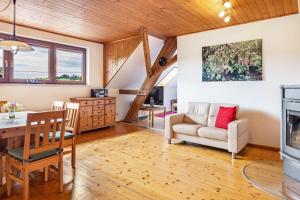 a living room with a table and a fireplace at Ferienhaus Mülhaupt in Ühlingen-Birkendorf