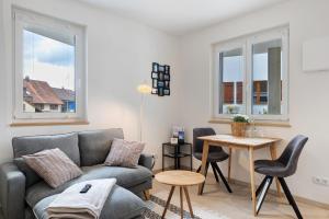 a living room with a couch and a table at Bodensee Apartment Lindau in Lindau