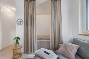a living room with a couch and a bed at Bodensee Apartment Lindau in Lindau