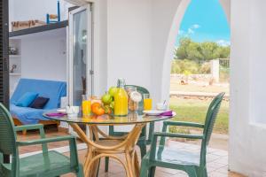 a table with fruit on it on a patio at Cala Serena Beach 6 in Felanitx