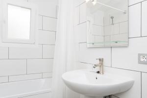 a white bathroom with a sink and a mirror at Cala Serena Beach 6 in Felanitx