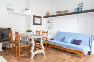 a living room with a blue couch and a table at Cala Serena Beach 6 in Felanitx +17 photos