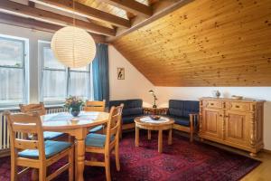 a living room with a table and a couch at Haus Kremeier in Kressbronn am Bodensee