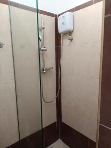 a shower with a glass door in a bathroom at Gorgona in Loutra