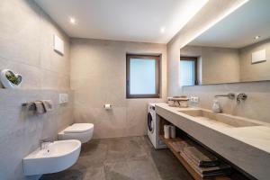 a bathroom with a sink and a toilet at Sunnseitn Lodge Exclusive Panorama in Moso