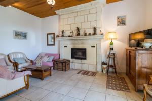 a living room with a fireplace and a couch at Belle Ferme Périgourdine in Sainte-Foy-de-Longas +21 photos