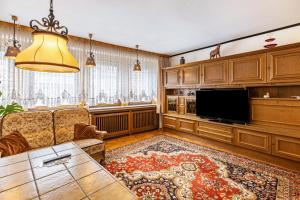 a living room with a couch and a flat screen tv at Haus am Markt Fewo 2 in Schöningen
