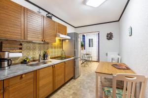 a kitchen with wooden cabinets and a wooden table at Haus am Markt Fewo 2 in Schöningen