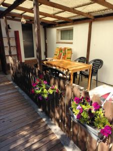 a patio with a wooden table and chairs and flowers at Haus im Grünen in Calau