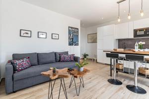 a living room with a gray couch and a kitchen at Casa Majina in El Islote +14 photos