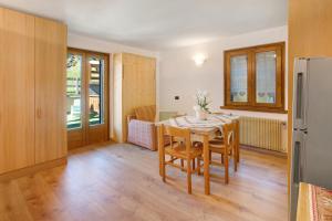 a kitchen and dining room with a table and chairs at Appartamenti Vittoria Bilo in Valfurva +13 photos