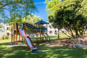 a playground with a slide in a park at Casa N's in Albufeira