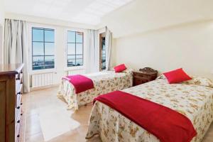 a bedroom with two beds and a window at Alcanada Paradise in Alcudia +14 photos