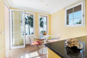 a dining room with a glass table and chairs at Alcanada Paradise in Alcudia
