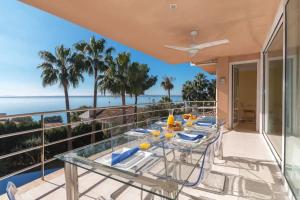 a balcony with a table and a view of the ocean at Alcanada Paradise in Alcudia