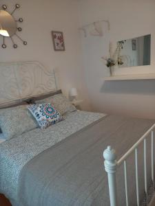 a bedroom with a bed with a pillow and a mirror at D'ouro Relax - Douro Vinhateiro in Sanfins do Douro