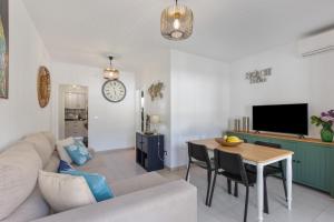 a living room with a couch and a table at Orion Beach in Puerto