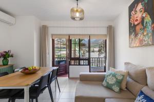 a living room with a couch and a table at Orion Beach in Puerto