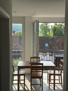 a dining room with a table and chairs and a window at Ferienwohnung Seescheune in Bodman-Ludwigshafen
