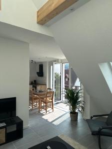 a living room with a table and a dining room at Ferienwohnung Seescheune in Bodman-Ludwigshafen