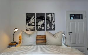 a bedroom with a bed and two pictures on the wall at Ferienwohnung Lichtenstein in Lichtenstein