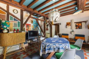 a living room with a table and chairs at La Closerie du Cassereau in Vernou-sur-Brenne