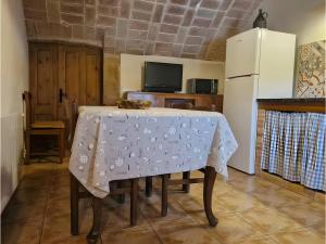 a kitchen with a table with a white table cloth on it at Mas Pareta - La Parra 1 in Fonolleras