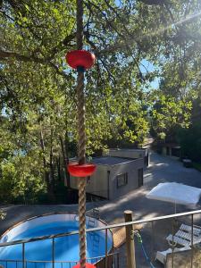 a pole with a rope around it next to a pool at Gerês Hideaway in Vilar da Veiga