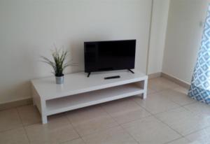 a white entertainment center with a flat screen tv on it at Los Cristianos plaza property in Los Cristianos