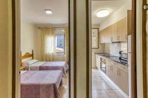 a hotel room with two beds and a kitchen at Apartamento la Siesta in L'Escala
