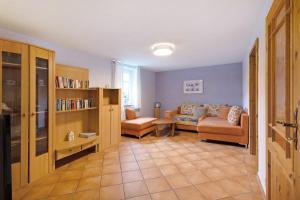 a living room with a couch and a chair at Teichmühle - Vogtland Chalet in Bad Brambach
