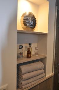 a shelf with towels and a mirror in a bathroom at Feichten Glück 16 in Siegsdorf