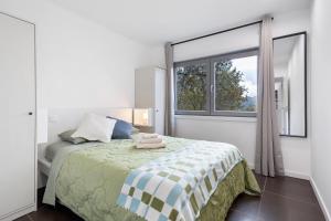 a bedroom with a bed and a large window at Gerês Hideaway in Vilar da Veiga +33 photos