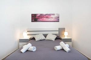 a bedroom with a large bed with two pillows at Casa Maria Jose in Cádiz +16 photos