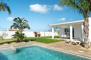 a swimming pool in front of a house at Casa Maria Jose in Cádiz