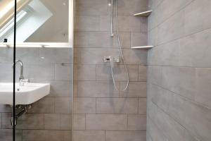 a bathroom with a shower and a sink at Haus Kirchenblick in Kalkhorst +18 photos