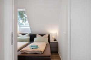 a small room with a couch with a window at Haus Kirchenblick in Kalkhorst