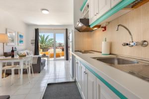 a kitchen with a sink and a dining room at Surf Home Sea View in Costa de Antigua