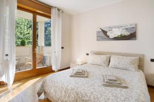 a bedroom with a bed with two towels on it at Casa Rosada Monza Autodromo in Nova Milanese