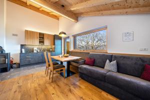 a living room with a couch and a table at Ferienwohnung Gruberhof in Verano +14 photos