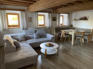 a living room with a couch and a table at Haus Peschl Fewo 1 in Neureichenau