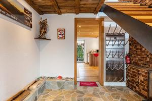 a home hallway with a staircase and a brick wall at Ferienhaus am Berg in Hirschau