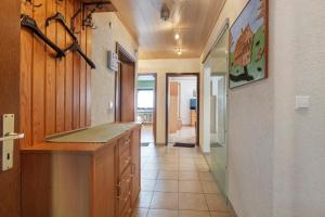 a large kitchen with a counter and a hallway at Apartment Alte Poststation in Wehr +13 photos