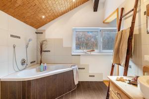 a bathroom with a tub and a sink at Ferienhaus am Berg in Hirschau +21 photos