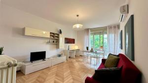 a living room with a red couch and a television at A casa di Deborah in Padova